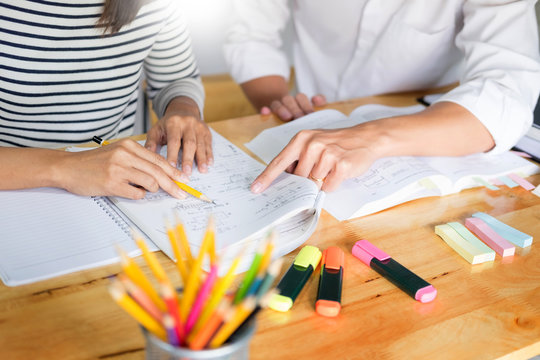 Tutor and student working through a chemistry problem together at a desk